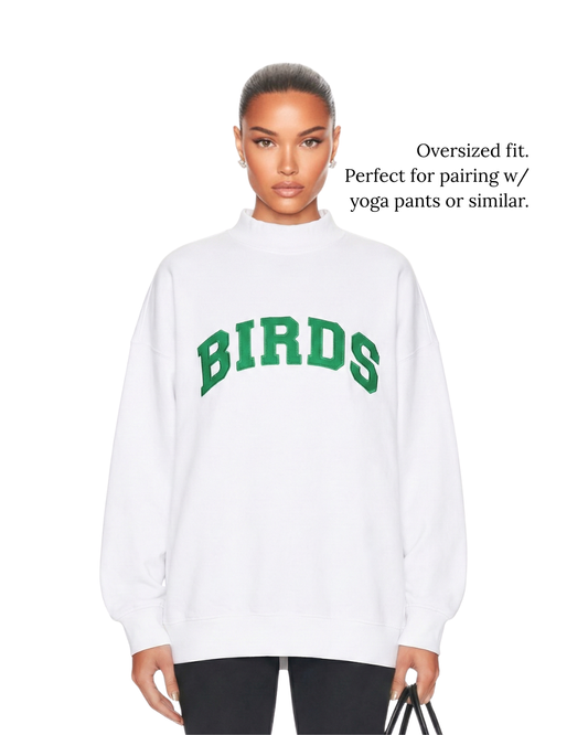 Model wearing South & Green's White BIRDS Varsity Mockneck in oversized fit sizing.