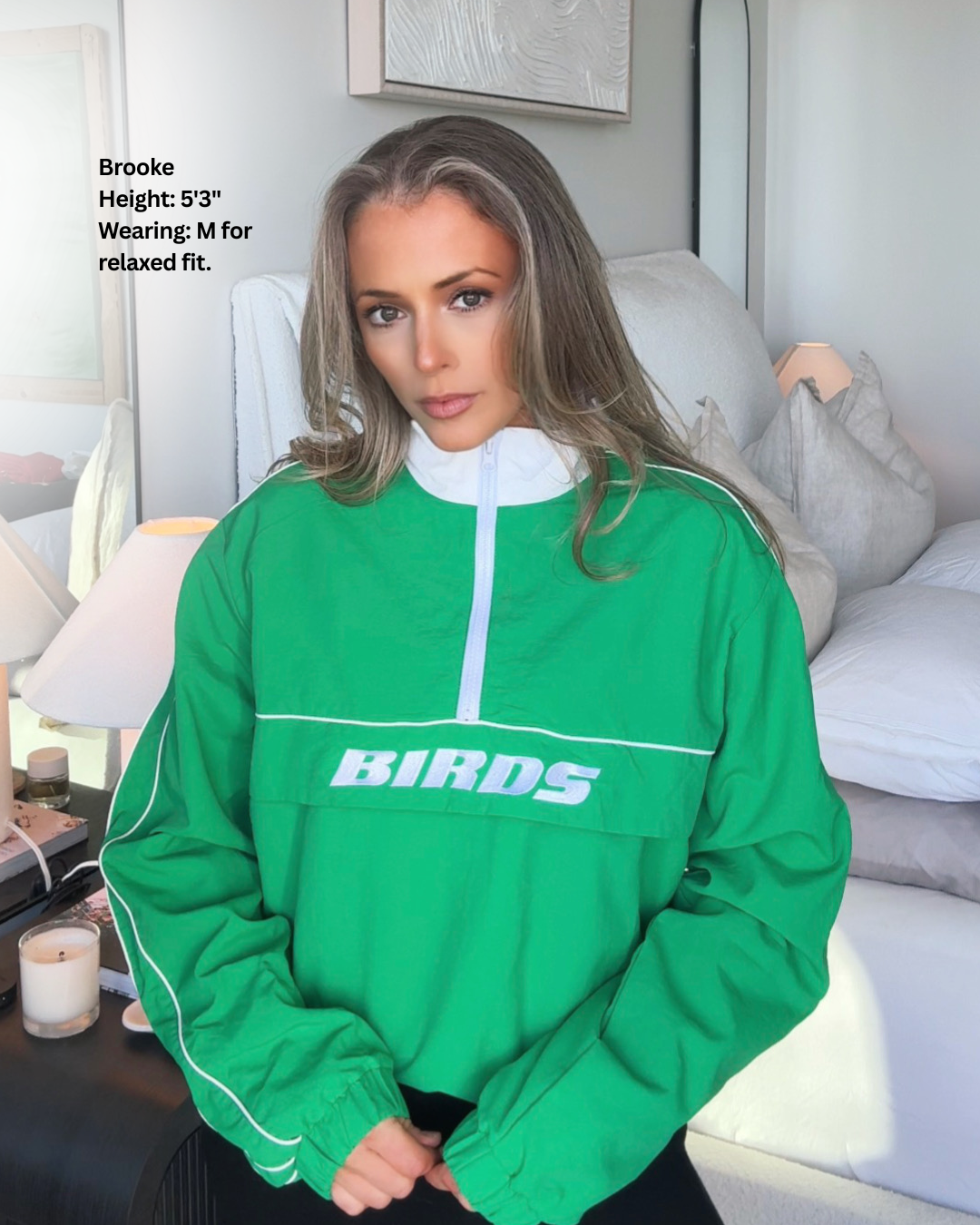 South & Green co-founder, Brooke, wearing South & Green's Kelly Green BIRDS Windbreaker in size M for relaxed fit.